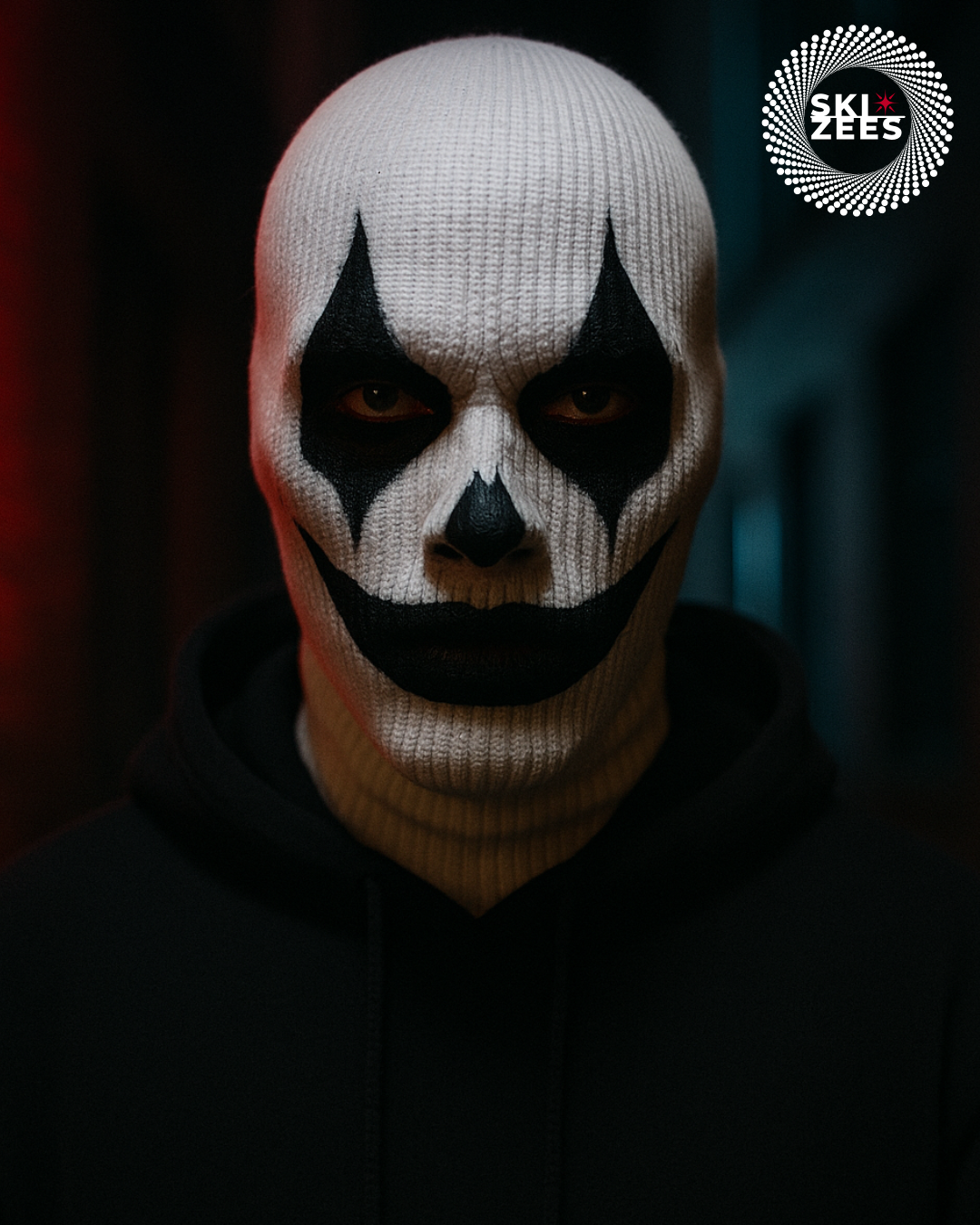 man wearing a white ski mask with black face paint as a killer clown
