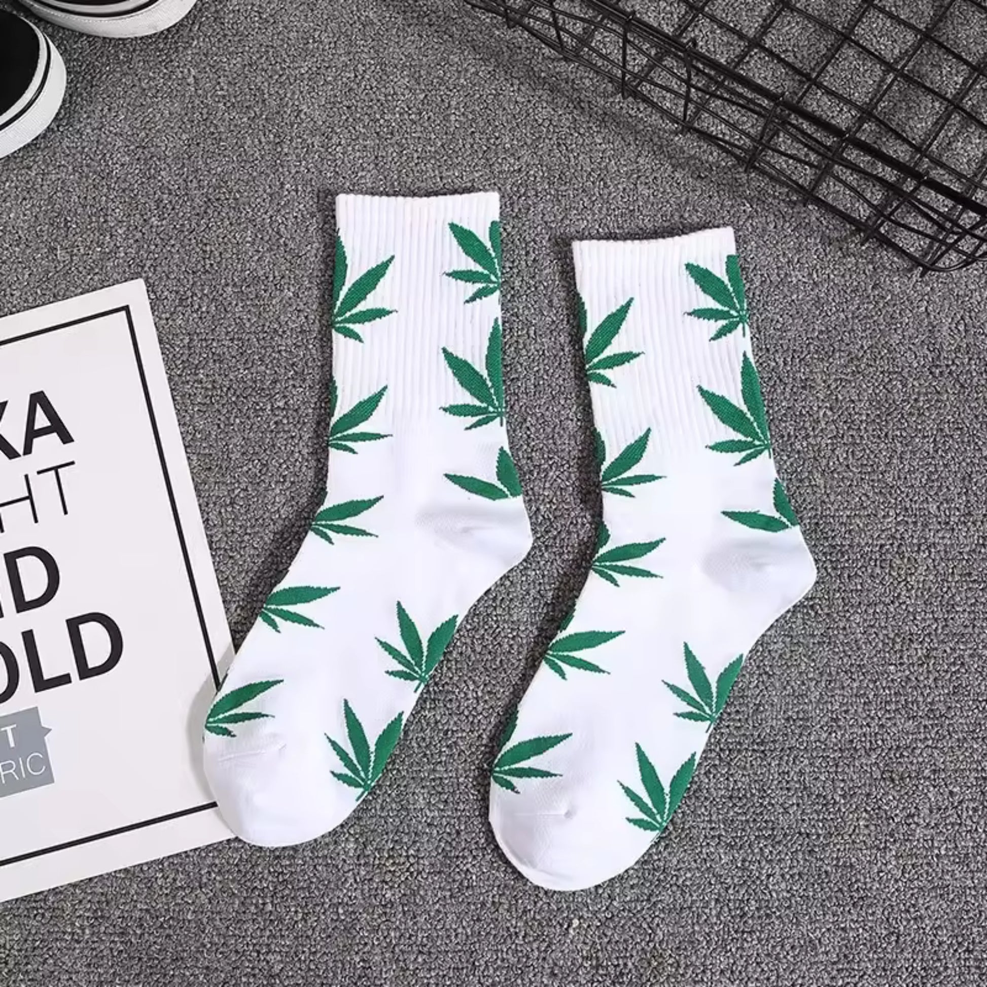 A pair of White and green marijuana leaf crew socks