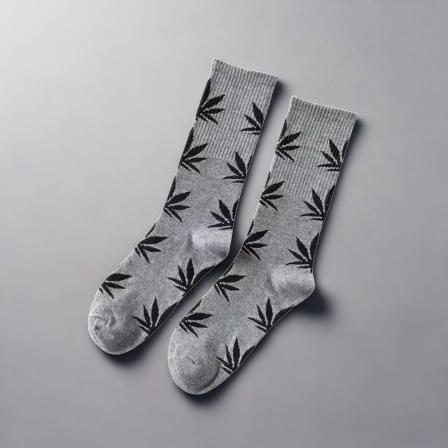 A pair of gray and black marijuana leaf crew socks 