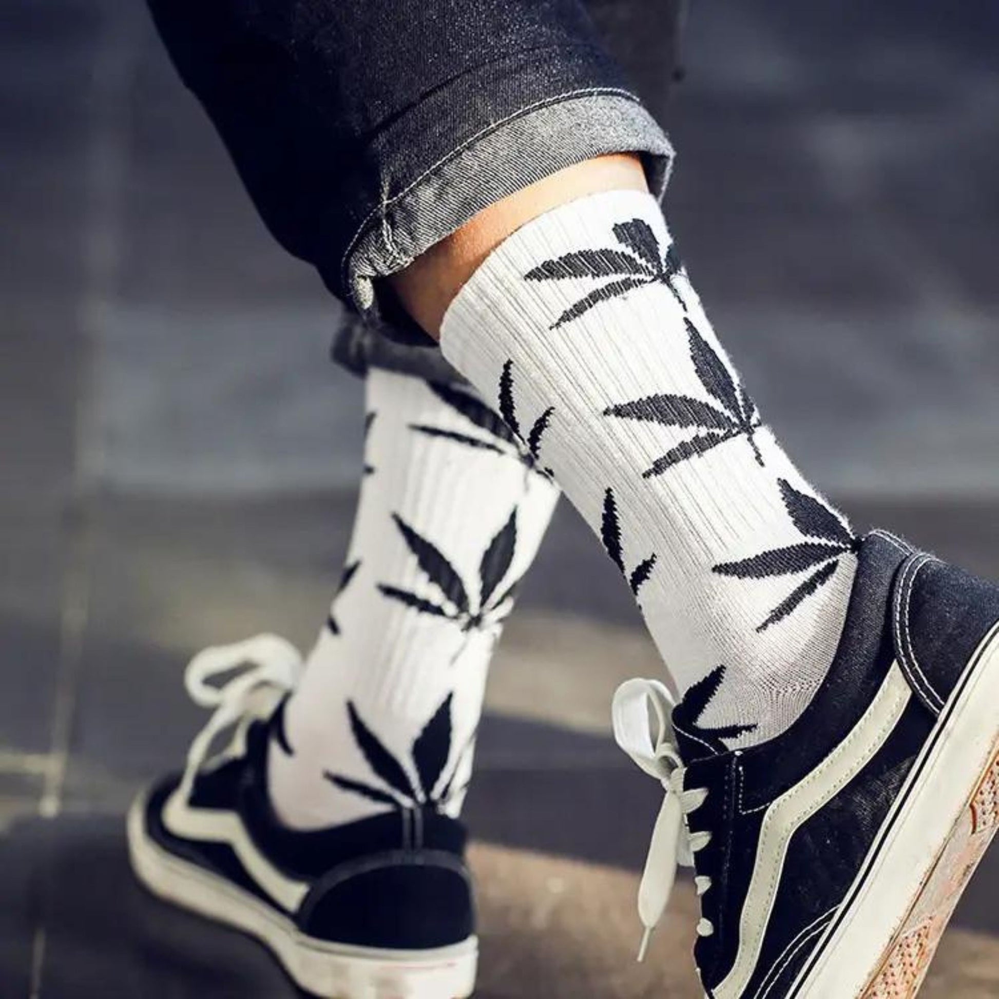 Walking around with white crew socks with black marijuana leaves