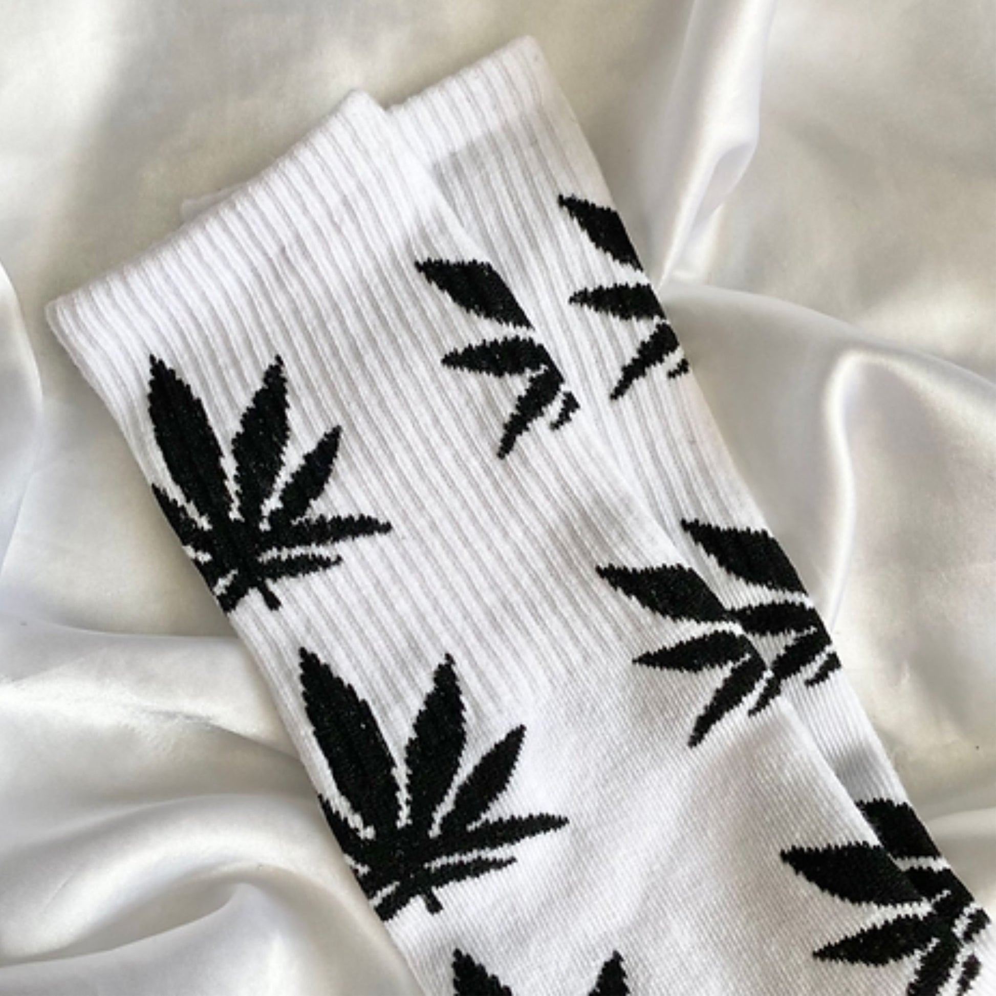 White weed socks on a silk blanket